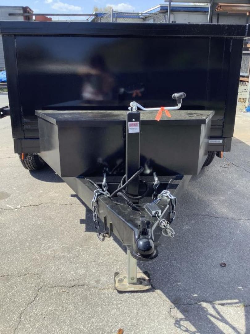 Black utility trailer on pavement