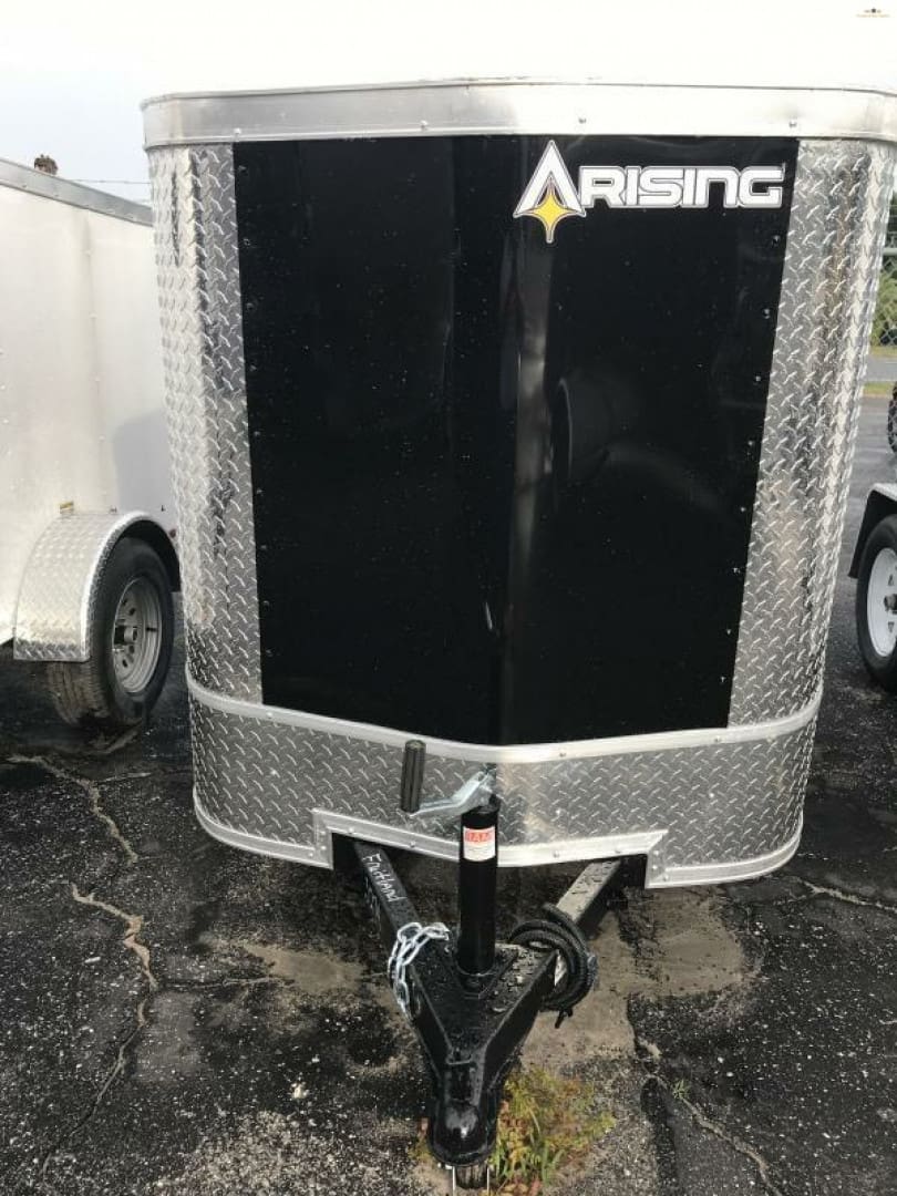 Enclosed utility trailer parked on asphalt