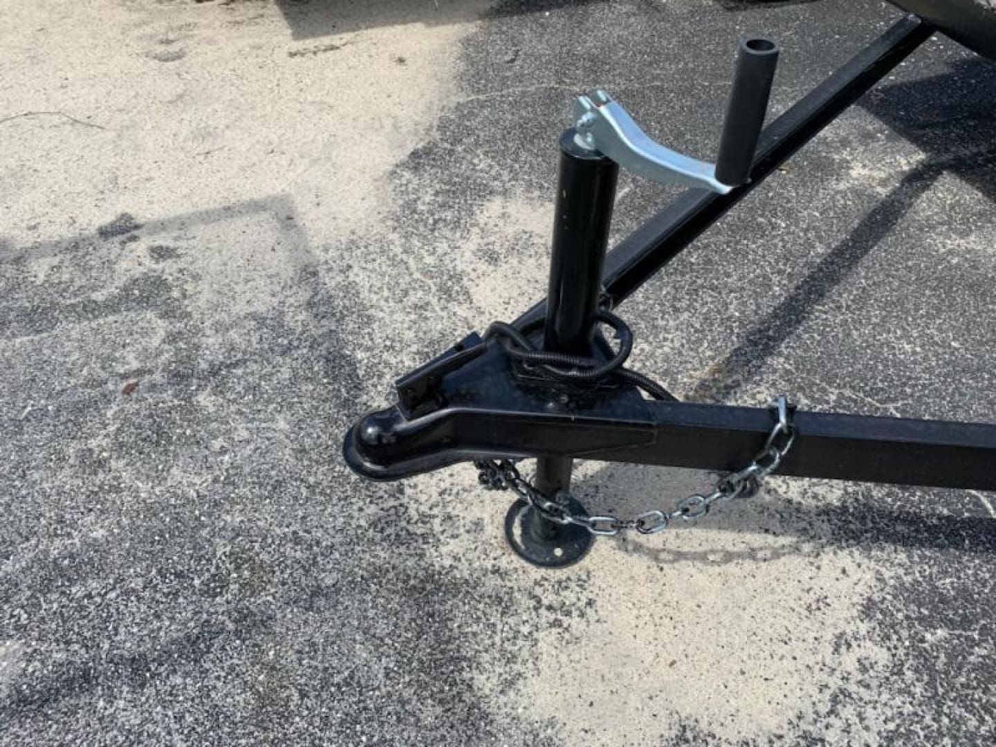 Black trailer hitch on asphalt surface