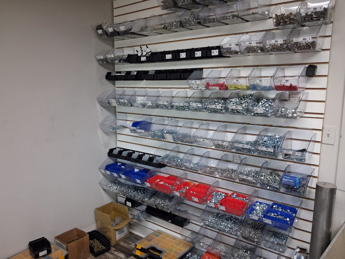 Organized hardware bins on slatwall display