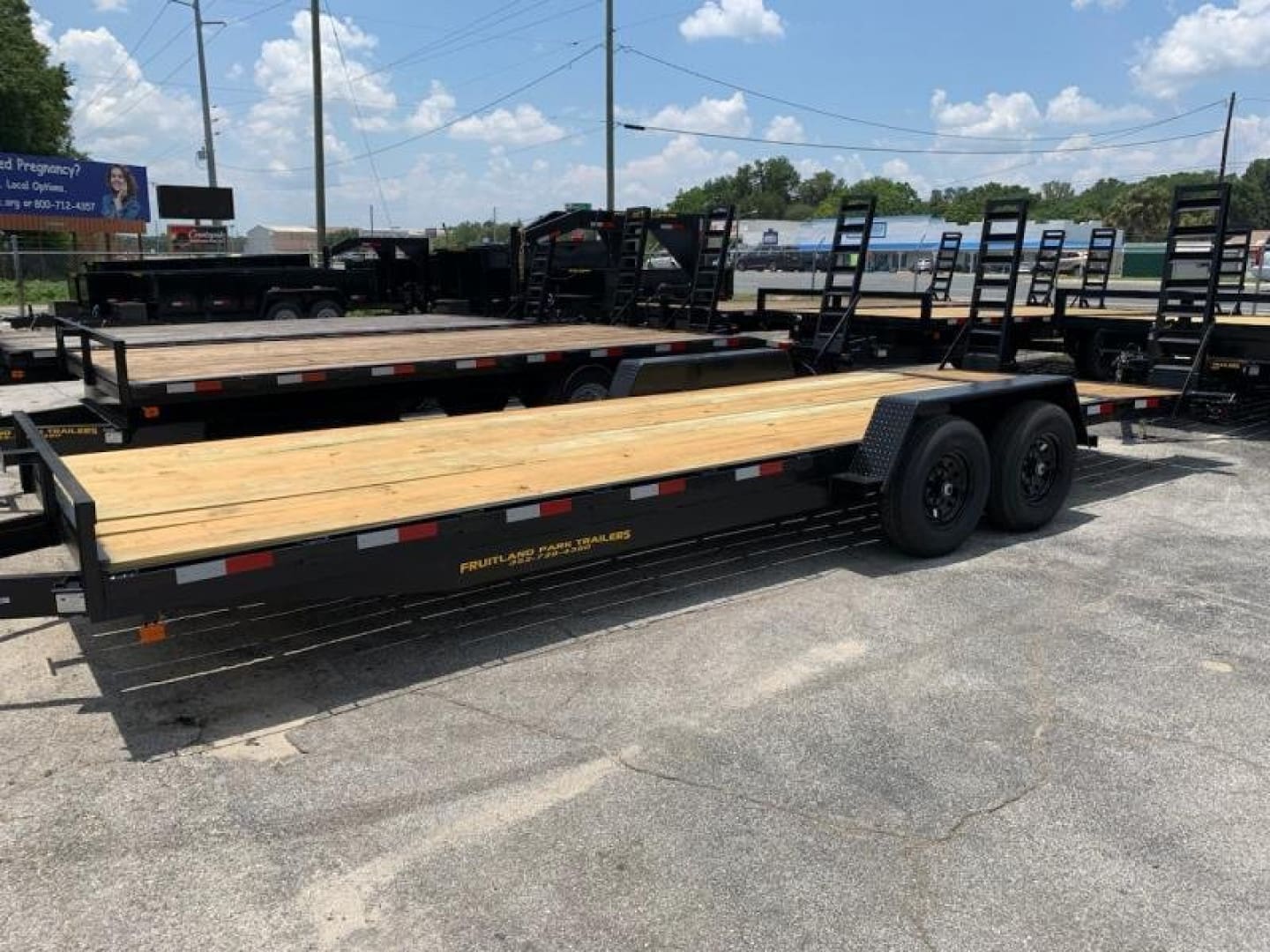Utility trailers under sunny sky