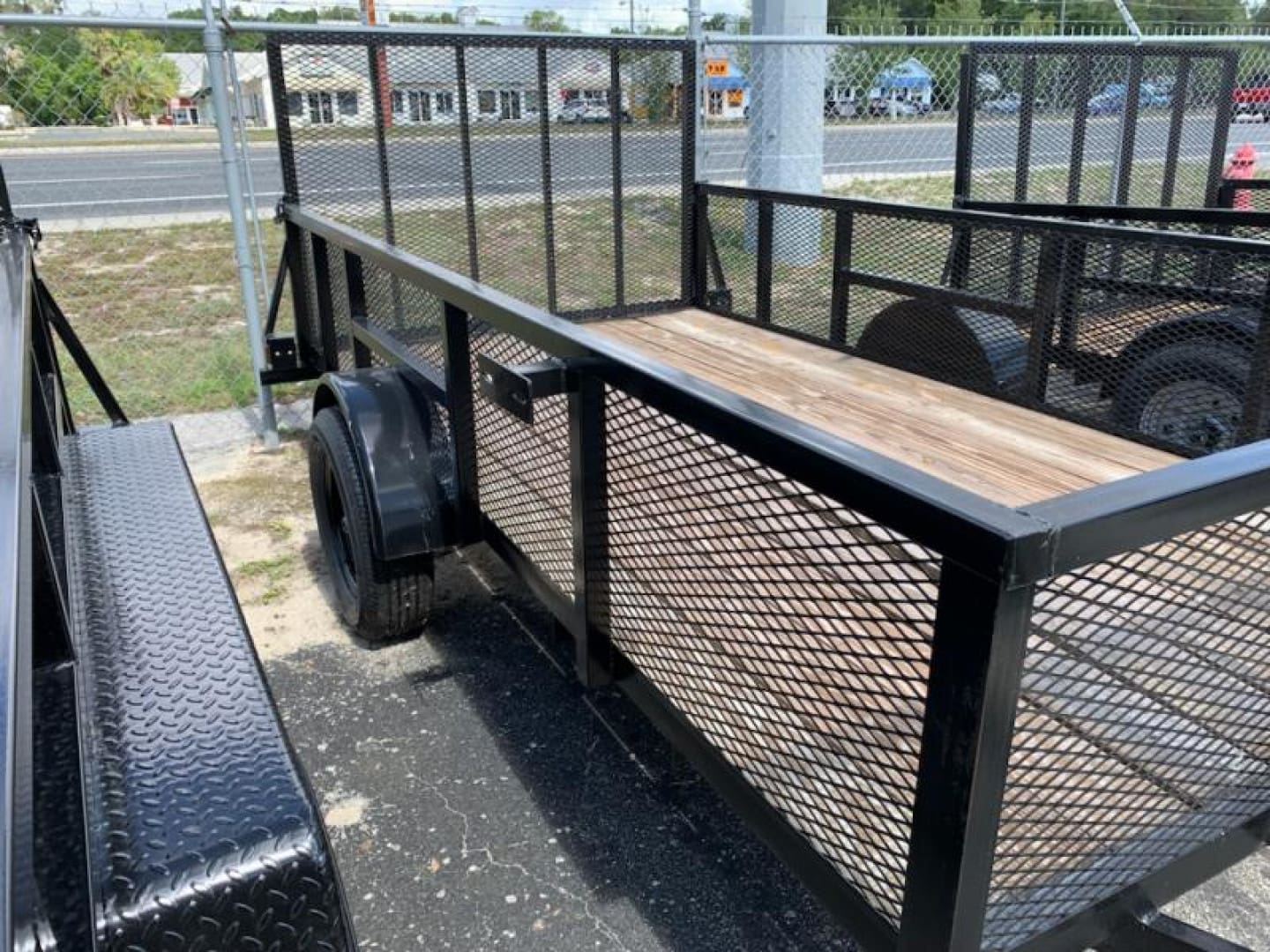 Flatbed utility trailer in parking lot