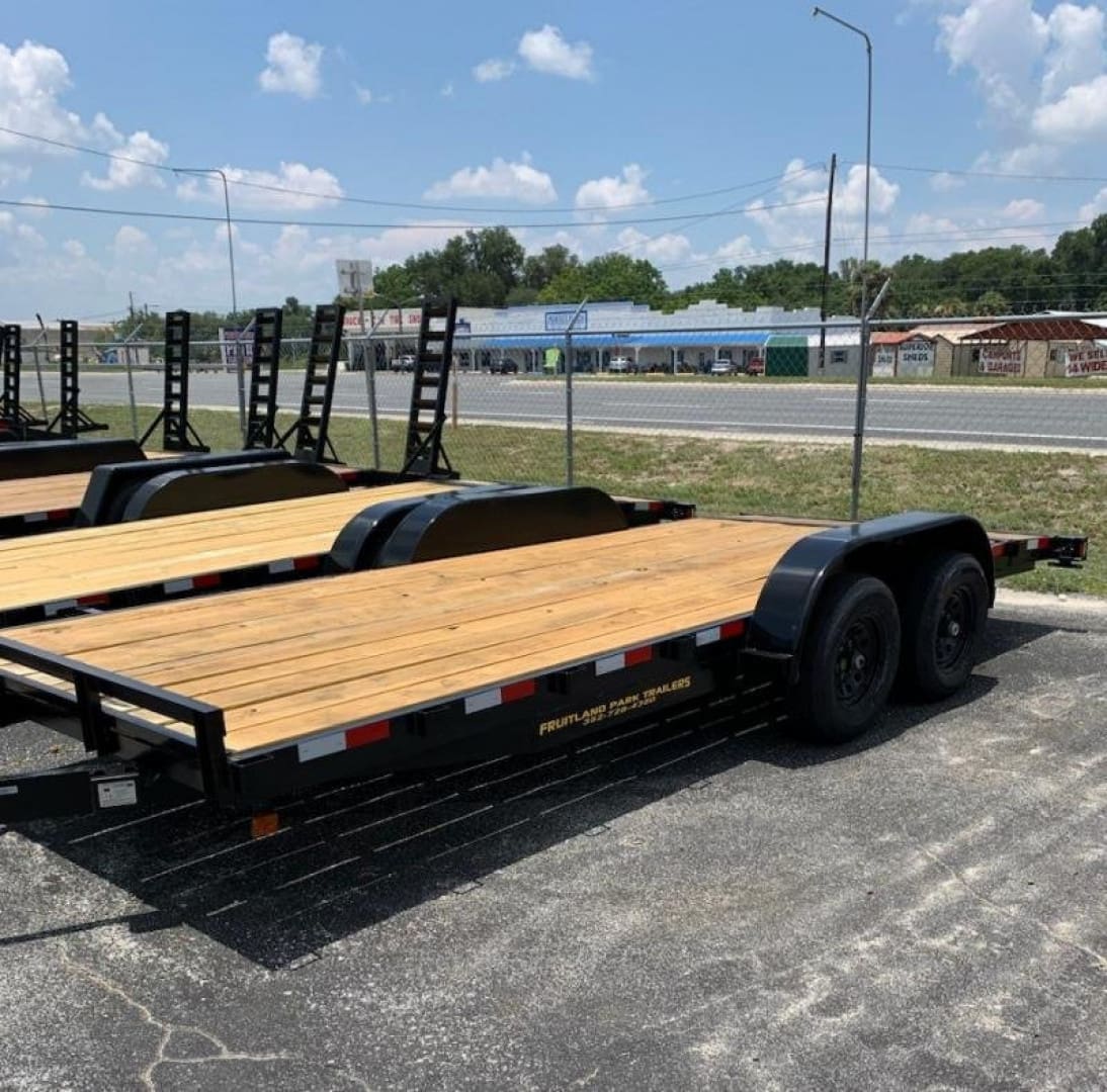 Flatbed trailer parked on asphalt lot.