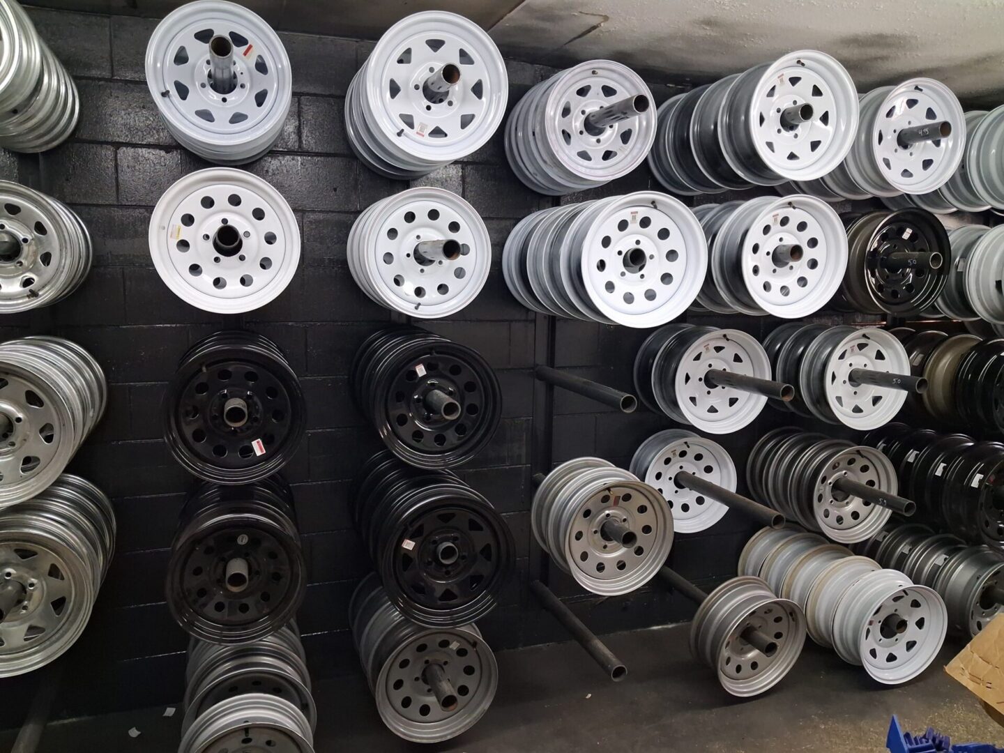 Stacked steel wheel rims on display
