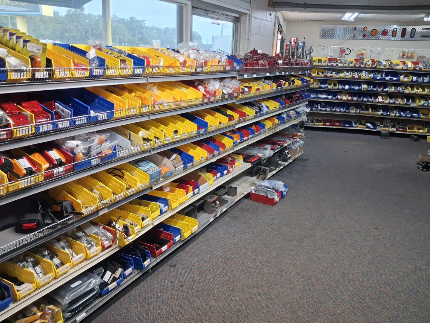 Hardware store shelves with colorful parts bins