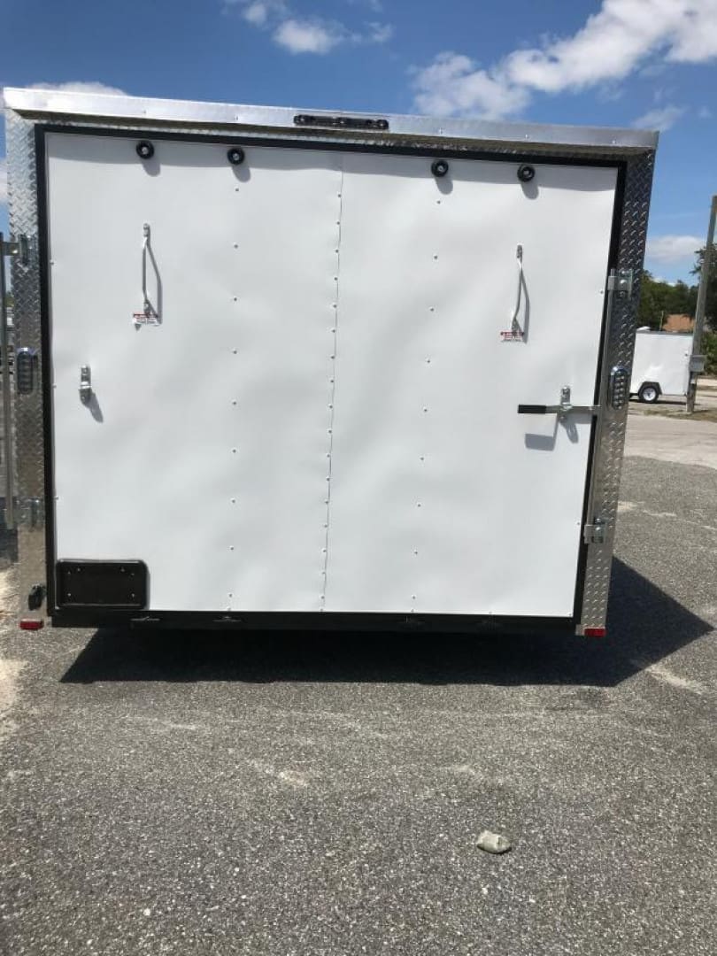 Trailer with metal frame on asphalt driveway