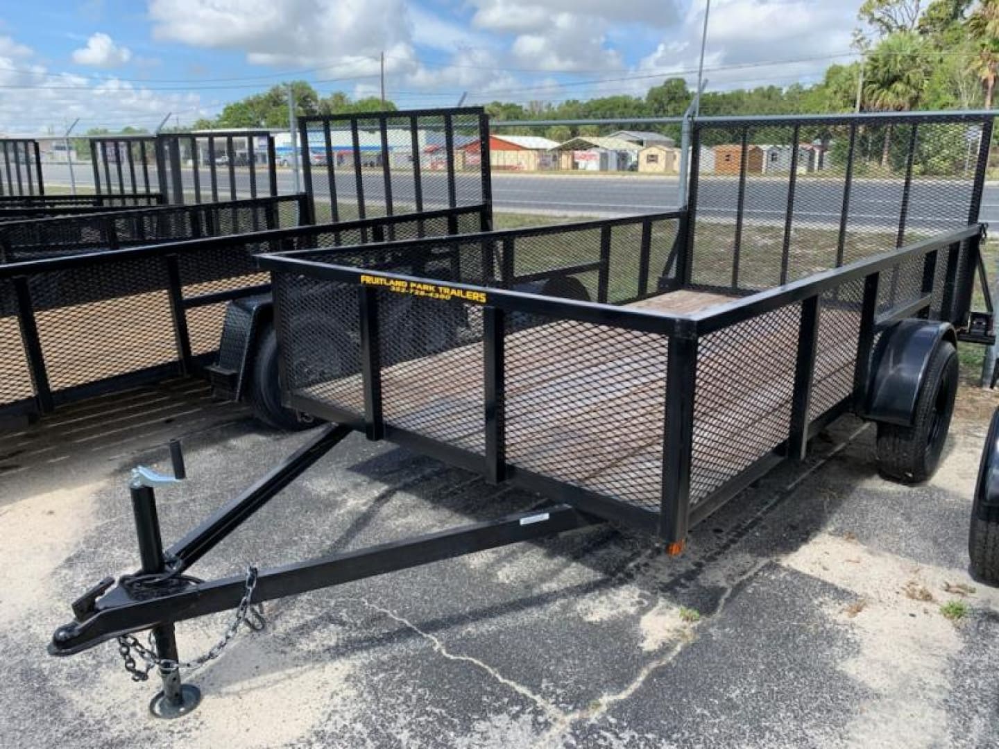 Black metal utility trailer outdoors