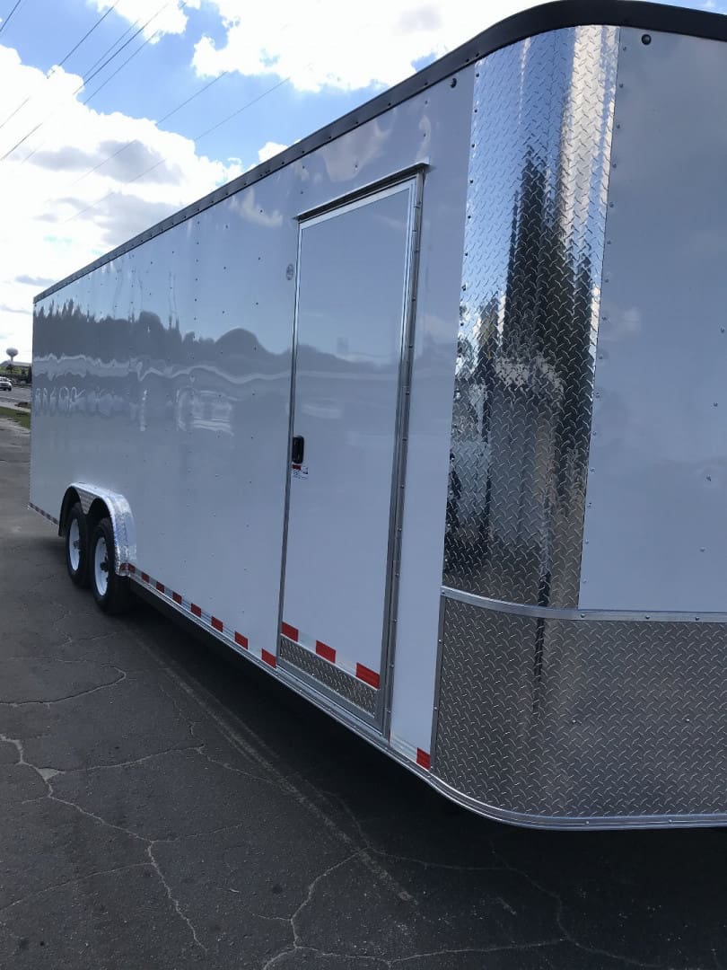 White cargo trailer with shiny chrome trim.