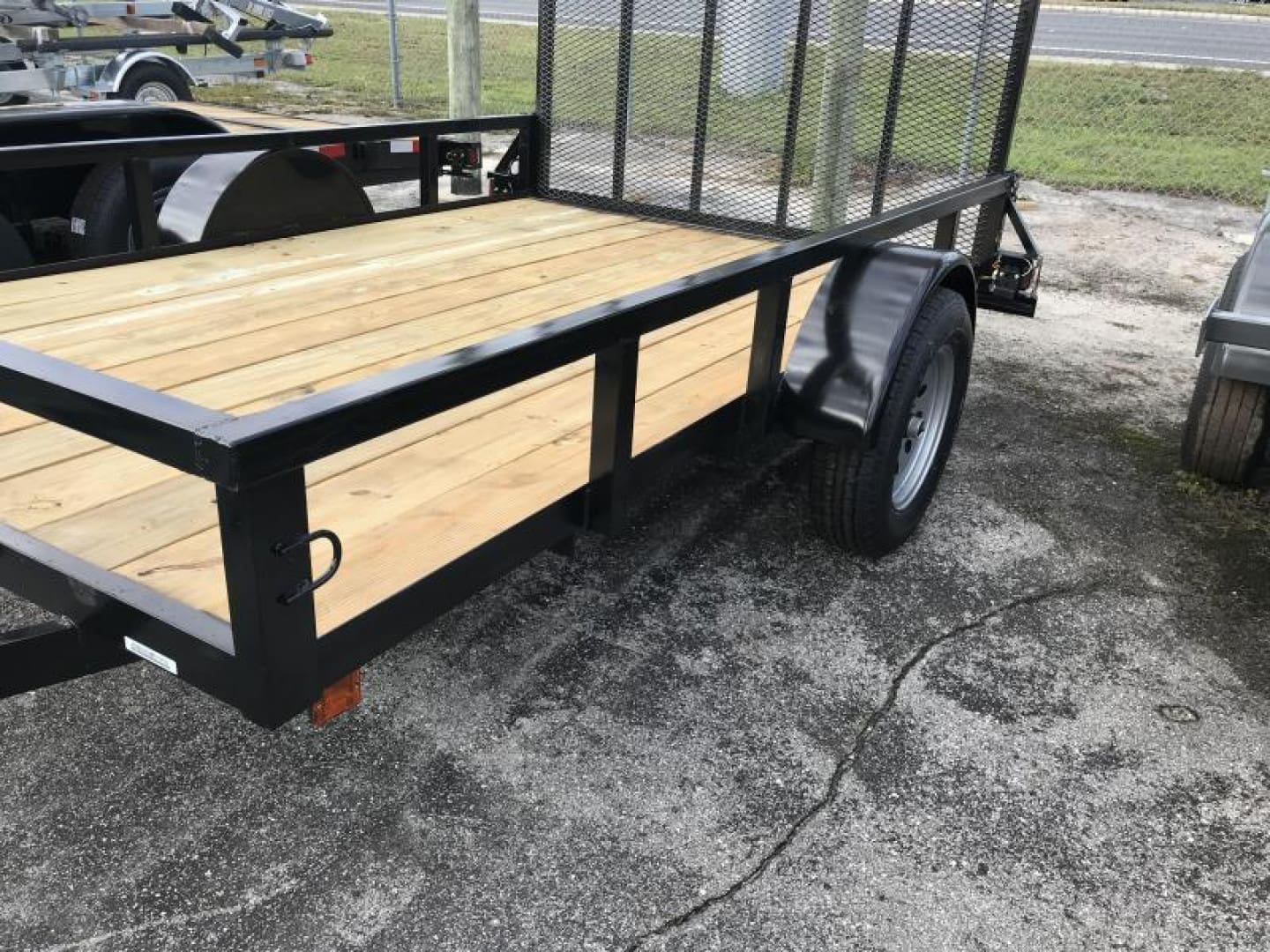 Empty metal-frame trailer parked outdoors