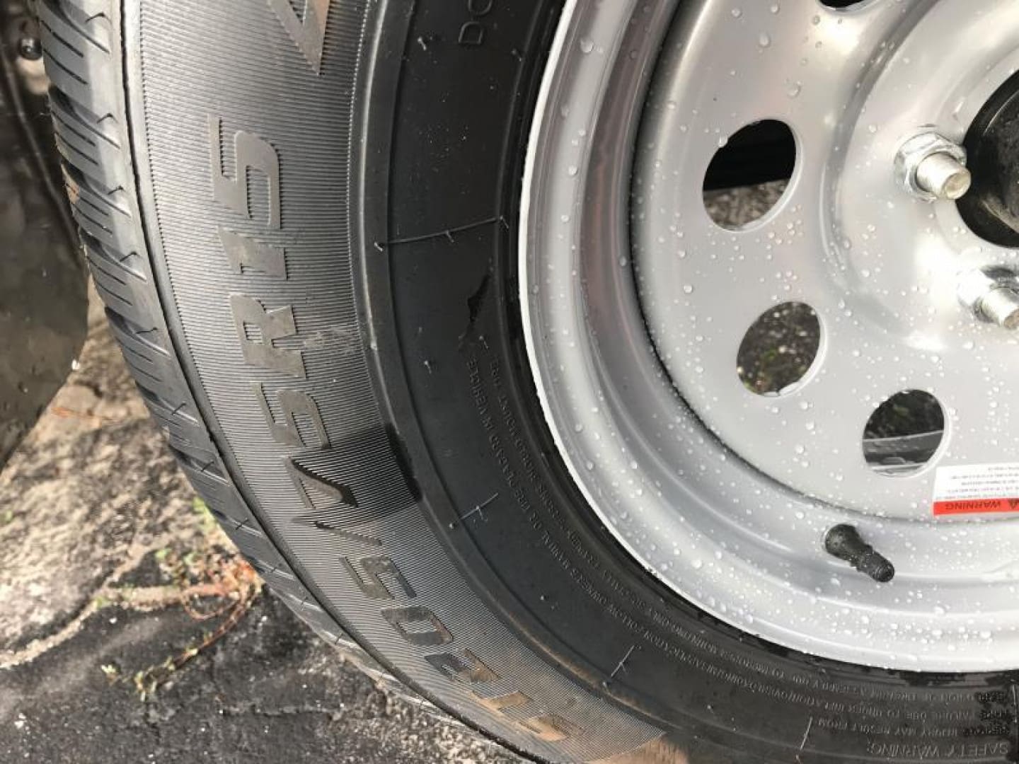 Raindrops on a car tire and wheel