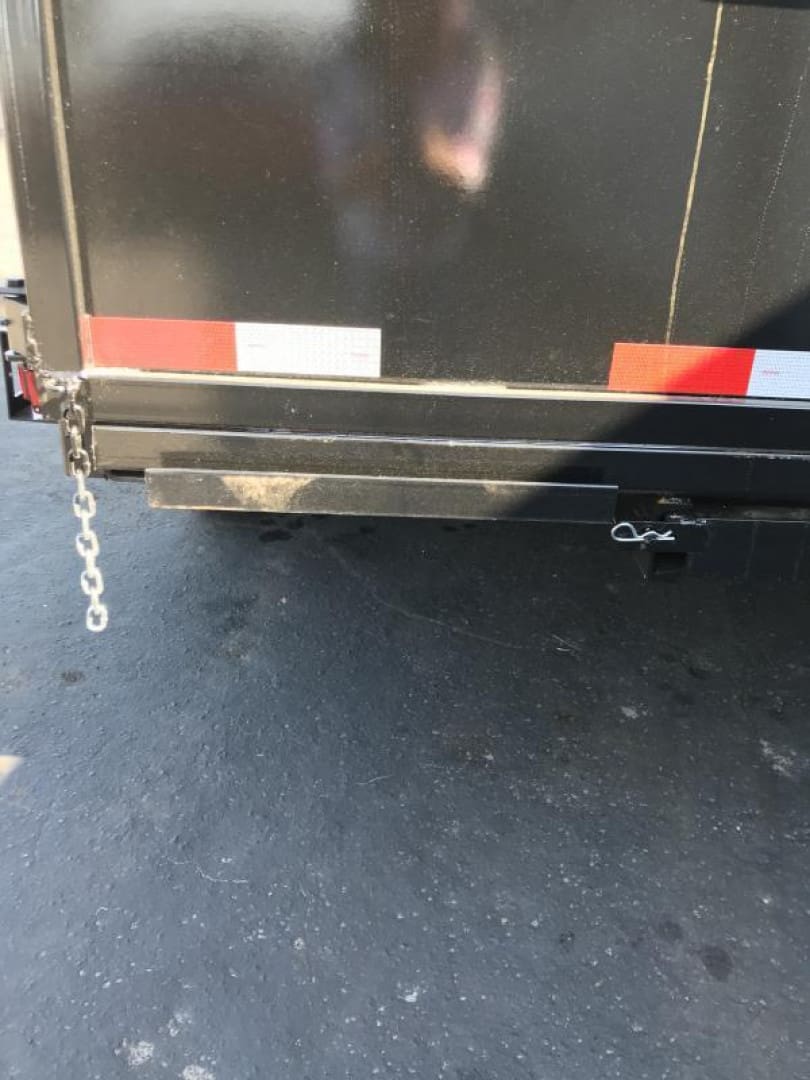 Trailer hitch and chain on asphalt.