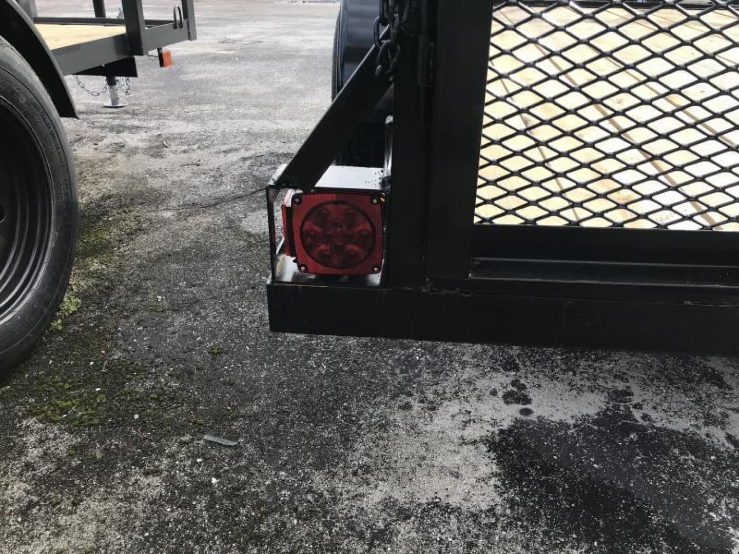 Trailer tail light and metal mesh gate