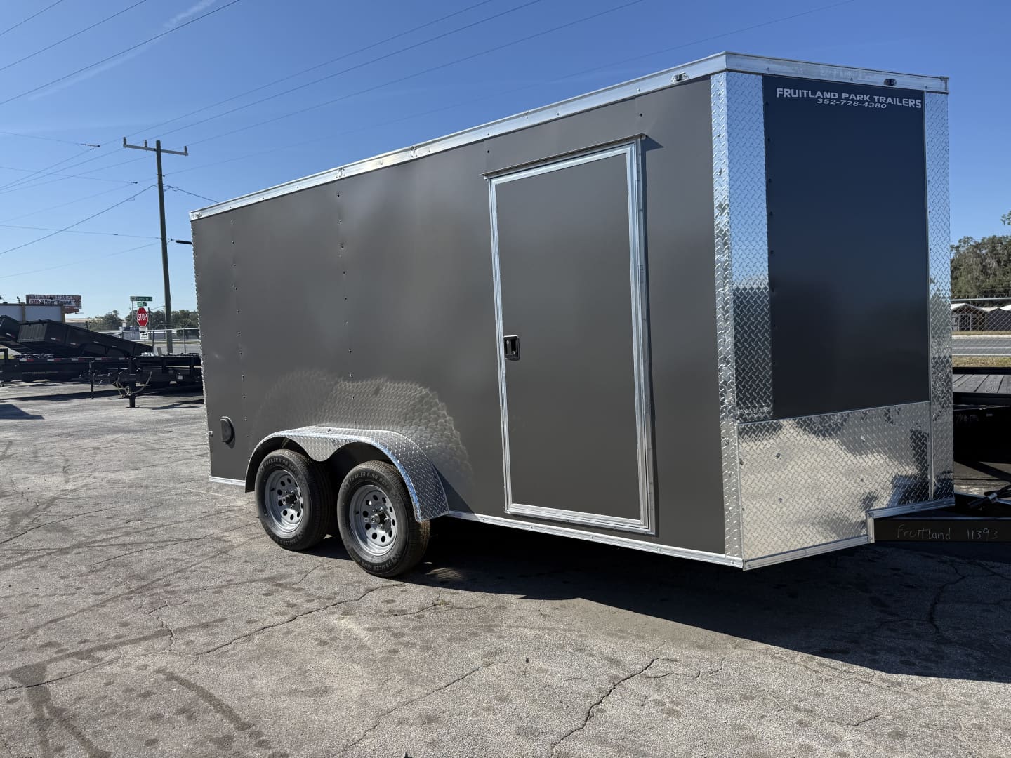 Metallic trailer with side door and wheels.
