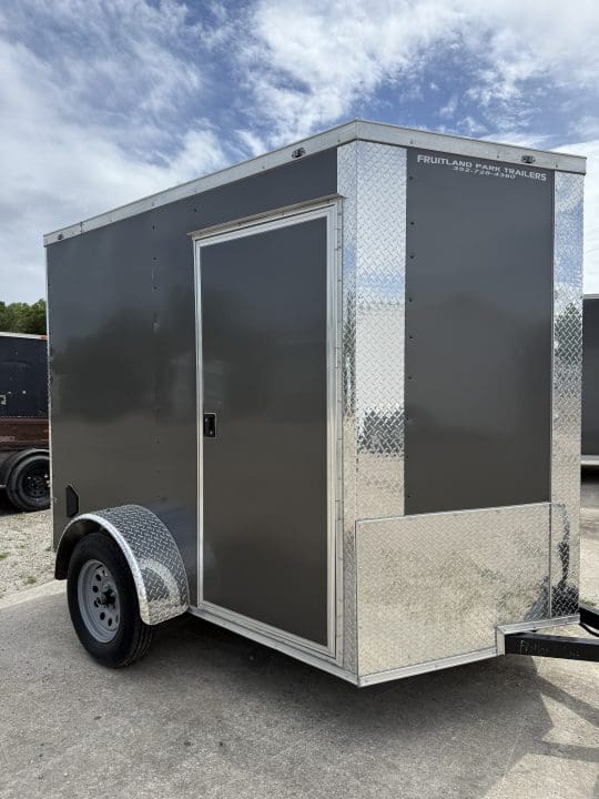 Compact cargo trailer under cloudy sky