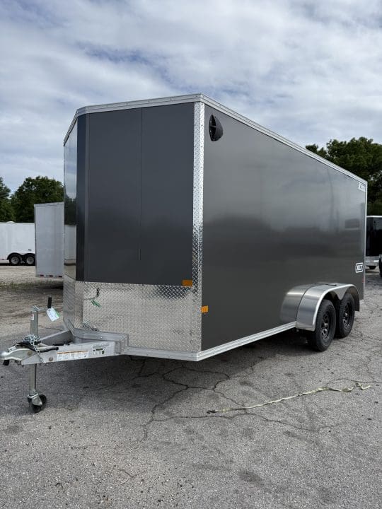 Gray enclosed cargo trailer parked outdoors.