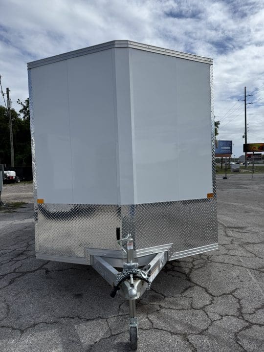 White utility trailer on cracked pavement