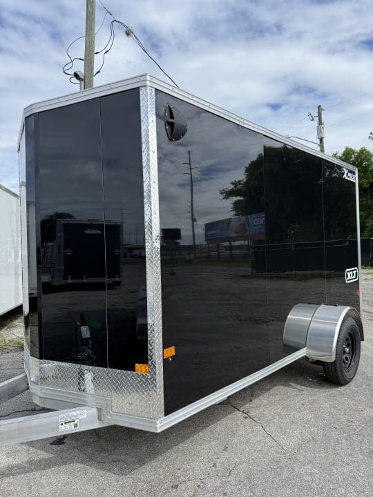 Black utility trailer parked outdoors