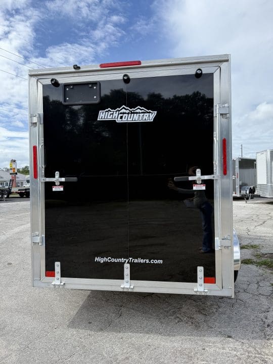 Black trailer with logo and website