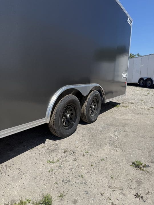 Enclosed trailer parked on gravel lot